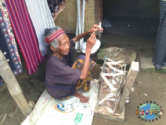 An elderly Sasak woman weaving in Lombok, Indonesia