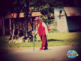 An elderly man walks around in a Tibetan Settlement in Pokhara