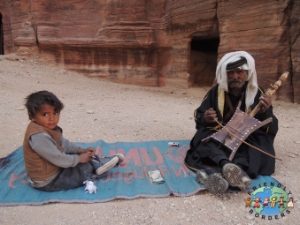 Bedouin grandfather plays the Rababa with grandson near Petra, Jordan