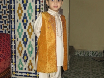 Little boy in a traditional dress in a home in the old city of Fes