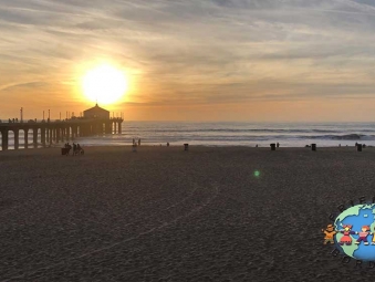 People watch the sunset in Manhattan Beach, California