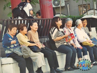 A group of elderly Japanese women relax on the street in Yokohama, Japan