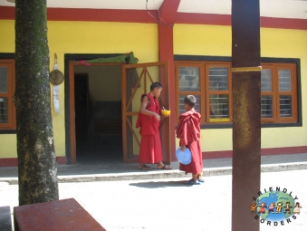 Tibetan boy monks eat lunch in a monastary in Pokhara